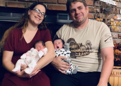 A happy family from Babytree Surrogacy smiles together, showing the joy and love shared through surrogacy.